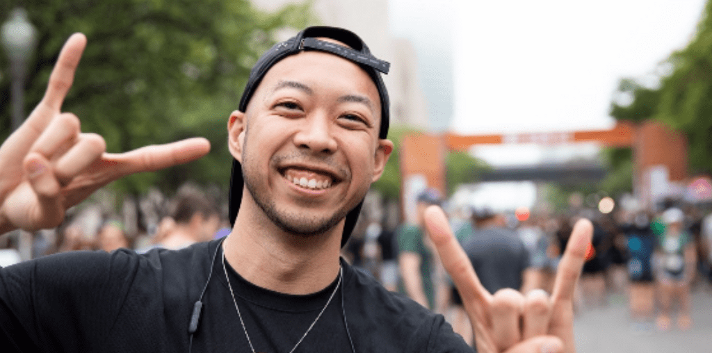 Daniel at a University of Texas event, showing "hook 'em" hand signs.