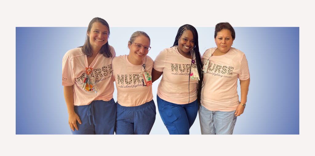 A group of pediatric hematology-oncology nurses at Texas Children's stand in a line with arms around each other. Their pink shirts say "NURSE."