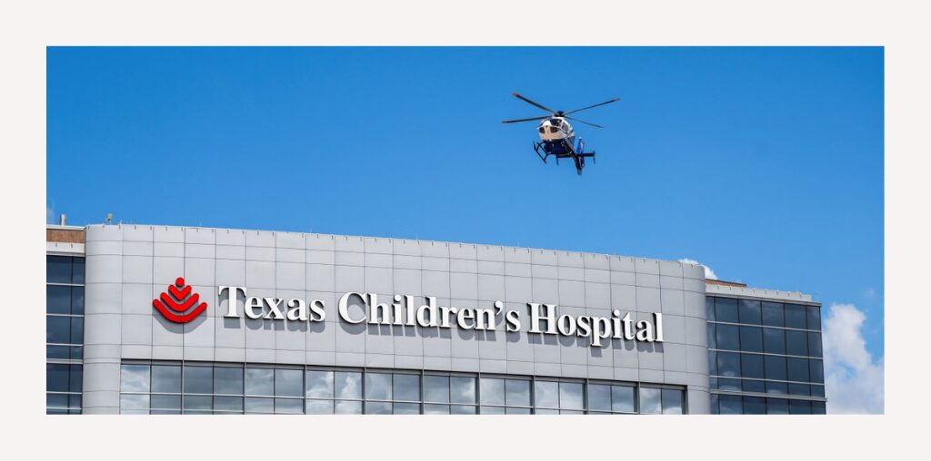 A helicopter flies over the rooftop at Texas Children's Hospital.